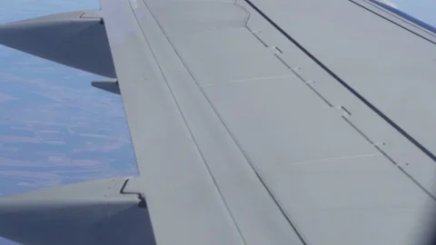 Airplane wing on a cloud background. Bird's-eye Stockbeeldmateriaal 101387666