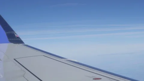 Airplane wing on a cloud background. Bird's-eye Stockbeeldmateriaal 101388741