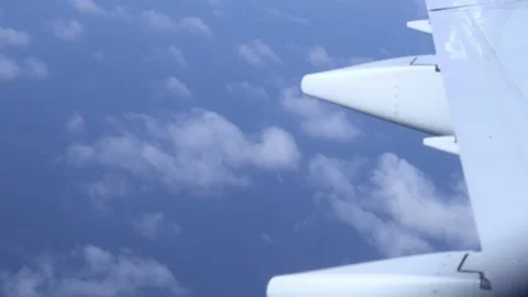 Airplane wing on a cloud background. Bird's-eye Stockbeeldmateriaal 101389803