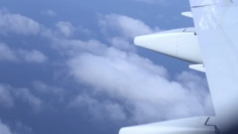 Airplane wing on a cloud background. Bird's-eye Stockbeeldmateriaal 101390131