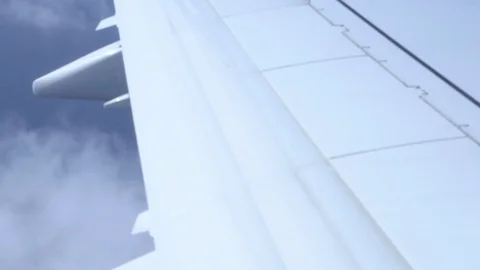 Airplane wing on a cloud background. Bird's-eye Stockbeeldmateriaal 101390546