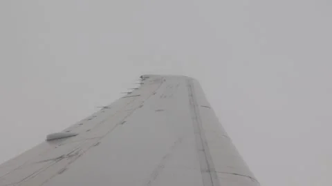 Airplane wing in the clouds Stock Footage 128751420