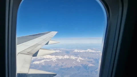 Airplane wing in the clouds. View from the porthole Stock Footage 284716648