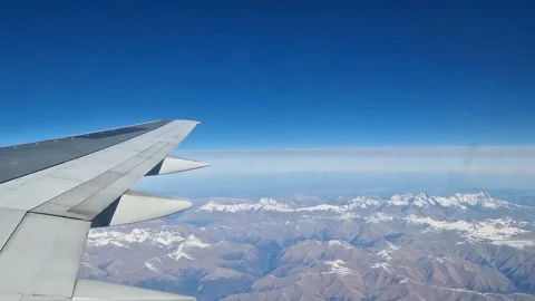 Airplane wing in the clouds. View from the porthole Stock Footage 284716700