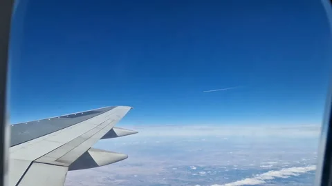 Airplane wing in the clouds. View from the porthole Stock Footage 284716939