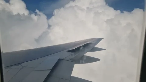Airplane wing in the clouds. View from the porthole Stock Footage 284908733