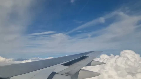 Airplane wing in the clouds. View from the porthole Video stock 284908764