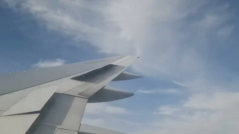 Airplane wing in the clouds. View from the porthole Stock Footage 284908910
