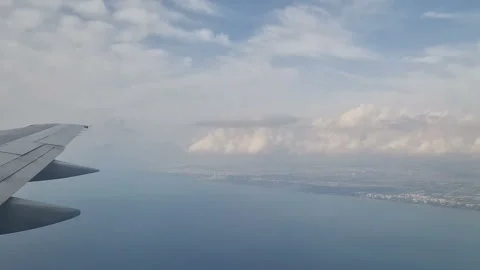 Airplane wing in the clouds. View from the porthole Stock Footage 285017222