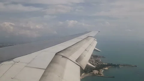 Airplane wing in the clouds. View from the porthole Stock Footage 285620822