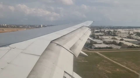 Airplane wing in the clouds. View from the porthole Stock Footage 285621259