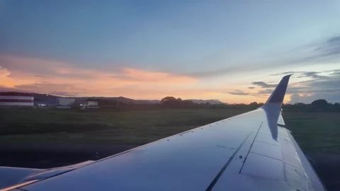 Airplane Wing with Cloudscape and Sunset Horizon View Stock Footage 312749914