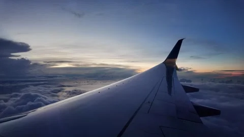 Airplane Wing with Cloudscape and Sunset Horizon View Stock Footage 312751359