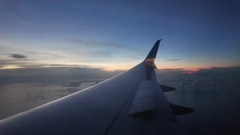 Airplane Wing with Cloudscape and Sunset Horizon View Stock Footage 312751570
