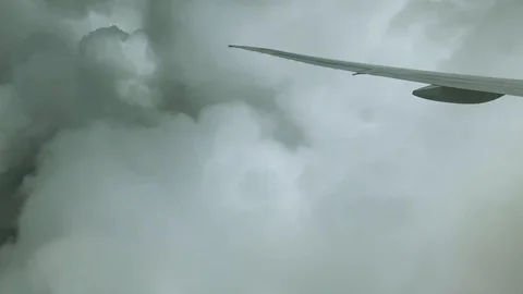 Airplane Wing Cuts Through Clouds co Stock Footage 115661697
