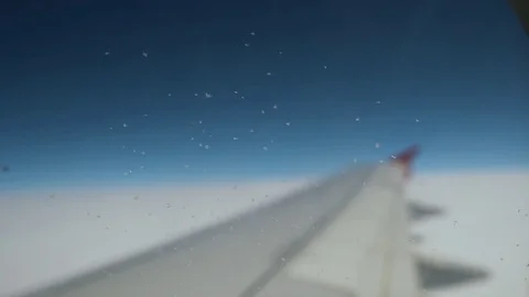 Airplane wing during the flight on cloudless sky Stock Footage 77621557