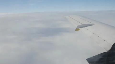 Airplane wing during flight by clouds Stockbeeldmateriaal 10790403