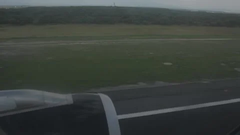 Airplane wing during runway touchdown over green field Stock Footage 340400197