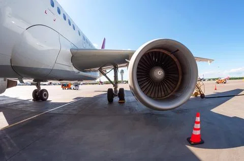 Airplane wing with engine, view under the plane during flight service. 写真素材
