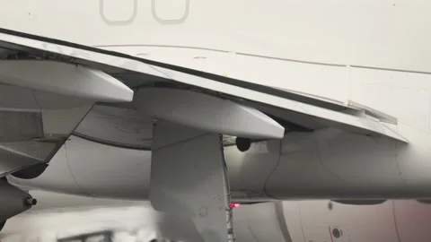Airplane wing flaps extending during taxiing Stock Footage 306357320