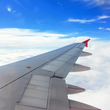 Airplane wing in flight, looking through window Stock Photos