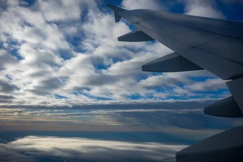 Airplane Wing in Flight, looking through window Stock Photos