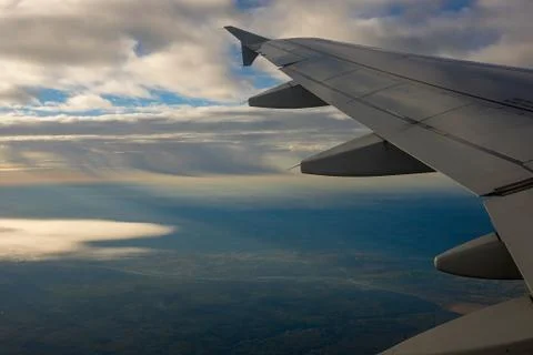 Airplane Wing in Flight, looking through window Stock Photos
