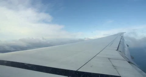 Airplane wing flying above the clouds Stock Footage 132418025
