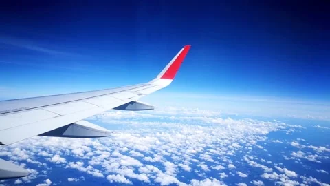Airplane wing flying above the clouds Stock Footage 137821773