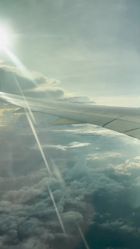 Airplane wing flying over clouds Stock Footage 305007167