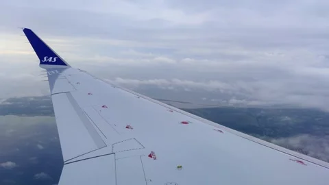 Airplane wing flying over Denmark landscape from passenger pov Видео 280850212