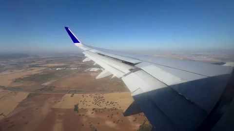 Airplane Wing Flying Over Rural Landscape During Golden Hour Stock Footage 346884884