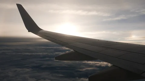 Airplane wing flying over sunset cloud with the golden sun. Stock Footage 93046455