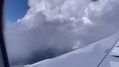 Airplane wing flying through a cloudscape Stock Footage 336603167
