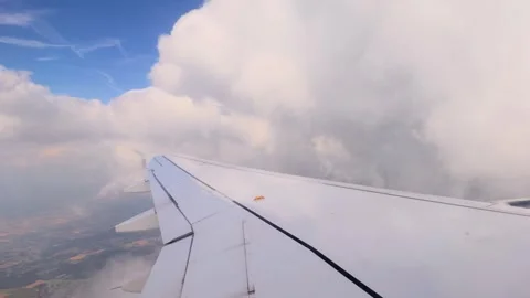 Airplane wing flying through thick white clouds Stock Footage 342201633