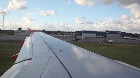 Airplane wing from inside driving through airport before take off Stock Footage 45070628