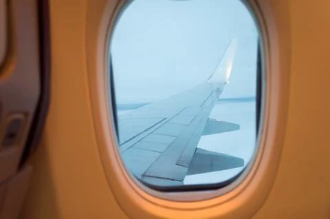 Airplane wing out of window Stock Photos