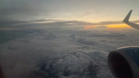 Airplane Wing Over Clouds Before Sunset Concept of Long Distance Travel Stock Footage 344248473