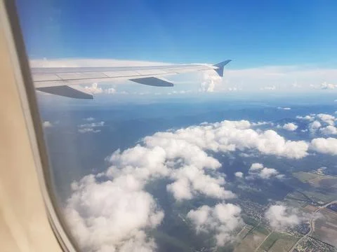 Airplane wing over clouds window view horizontal Stock Photos