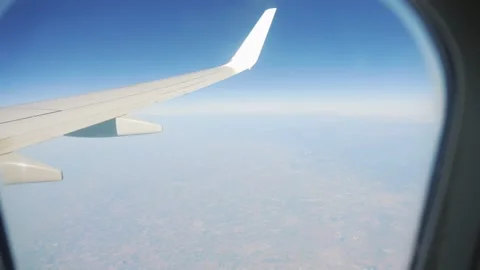 Airplane wing over earth terrain, showcasing the journey and perspective in.. Stock Footage 285122633