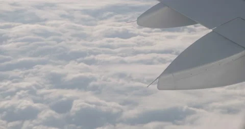 Airplane wing over sea of clouds. Window view, transportation, plane, aviation. Video stock 229128778