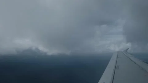 Airplane wing passing over the clouds in the middle of the Atlantic Ocean Stock Footage 204042604