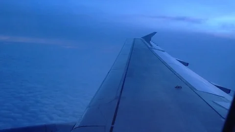 Airplane wing passing through epic clouds Stock Footage 98821425