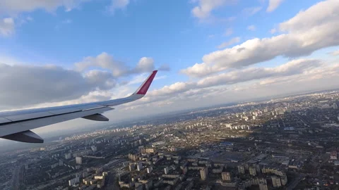 Airplane Wing with Purple Wingtip Soaring Over City and Airport During Clea.. Stock Footage 308094449