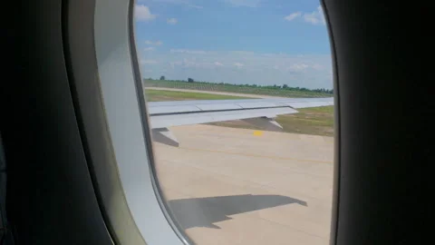 An airplane wing with a red tip stretches over a sea of clouds Video stock 307625452