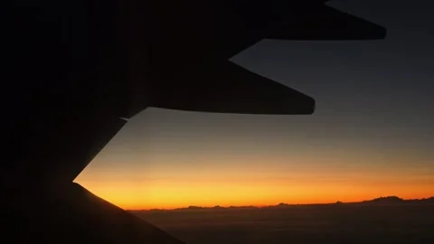 Airplane Wing Seen Through Window During Sunset Flight Video Stock Footage 341684007