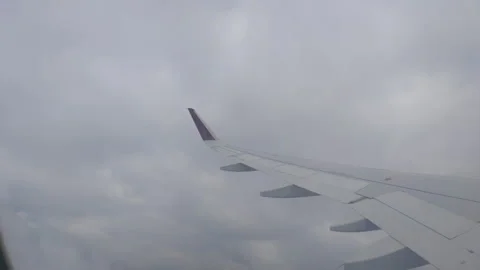 Airplane wing seen from window during flight Stock Footage 305033774
