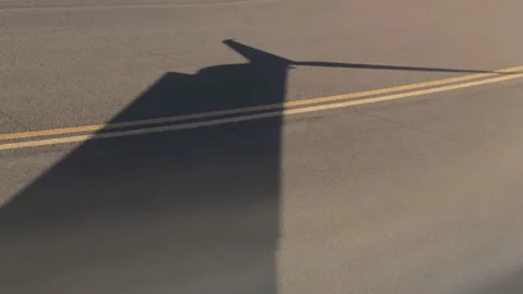 Airplane wing shadow resembling a kangaroo on the runway Stock Footage 301070249