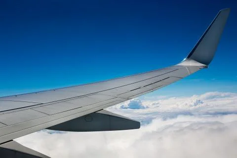 Airplane wing on sky background Stock Photos