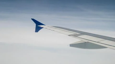 The airplane wing on the sky. Stock Photos